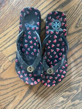 Tory Burch Black Flip Flops with Red Heart Pattern and Gold Logo